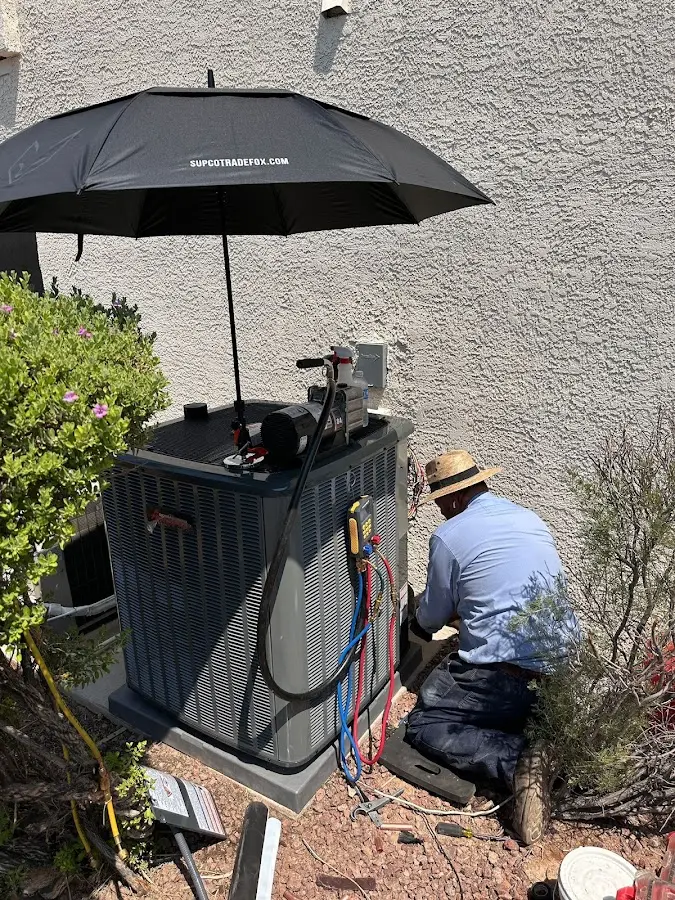 HVAC technician performing outdoor AC maintenance in Utica